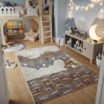 A premium-grade kids' rug featuring a highly durable, high-quality build that withstands constant activity. The pile is tightly woven to be incredibly soft and smooth, creating a comfortable surface for toys and games. The design showcases a weathered abstract center in neutral tones, finished with a clean geometric frame.
