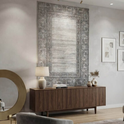 A high-quality area rug with a soft, uniform surface that feels smooth to the touch. The design showcases a distressed, abstract blend of grey and off-white in the center, bordered by a sharp, geometric frame. It offers a premium look and a comfortable feel without unnecessary embellishments.