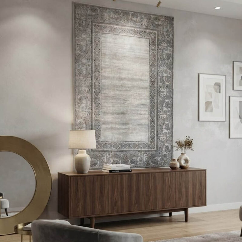 A high-quality area rug with a soft, uniform surface that feels smooth to the touch. The design showcases a distressed, abstract blend of grey and off-white in the center, bordered by a sharp, geometric frame. It offers a premium look and a comfortable feel without unnecessary embellishments.