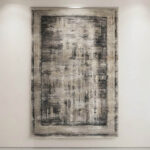 This-rug-features-an-understated-abstract-design-in-tones-finished-with-a-defined-geometric-border-along-the-edges