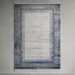 This soft-textured area rug combines a clean, neutral look with a distressed abstract design. Its smooth pile offers a premium feel underfoot while looking sharp on any floor.