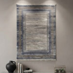 This soft-textured area rug combines a clean, neutral look with a distressed abstract design. Its smooth pile offers a premium feel underfoot while looking sharp on any floor.